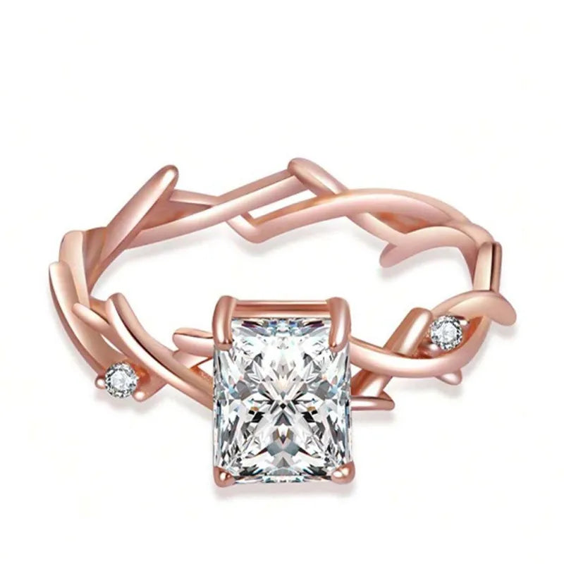 Rose gold ring with a large diamond and smaller diamonds on a white background