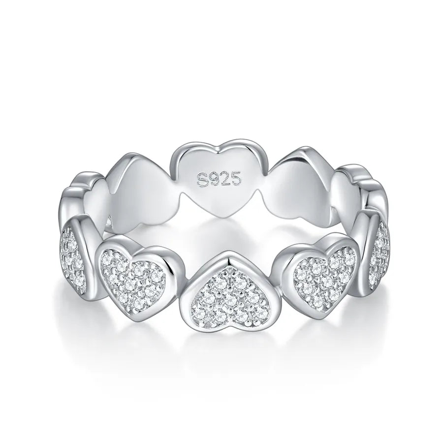 Silver ring with heart designs and 'S925' stamp on a white background