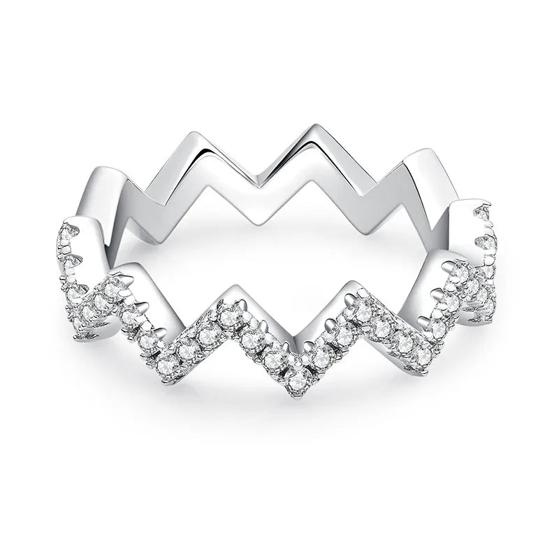 Silver ring with a zigzag design and embedded diamonds on a white background