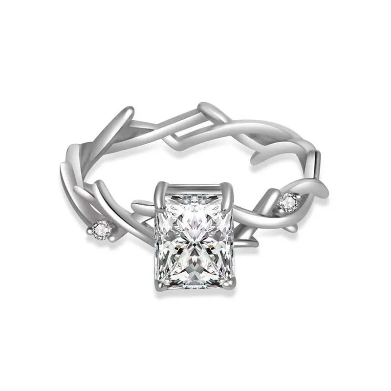 Silver ring with a central diamond and smaller diamonds on a white background