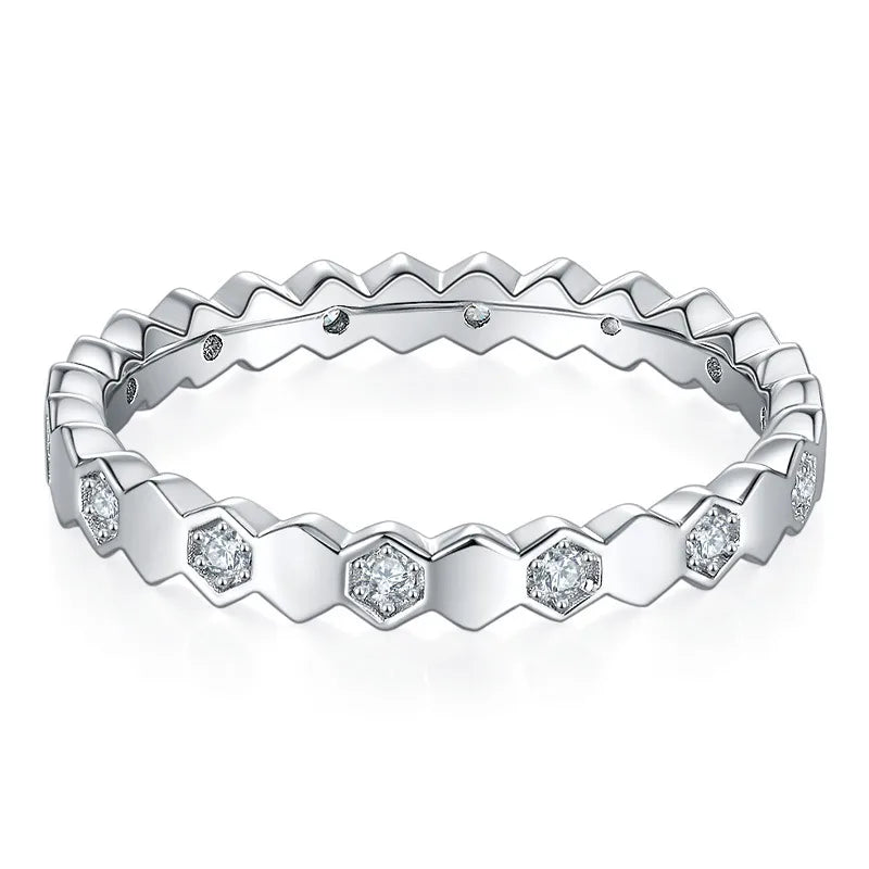 Silver ring with diamond accents on a white background