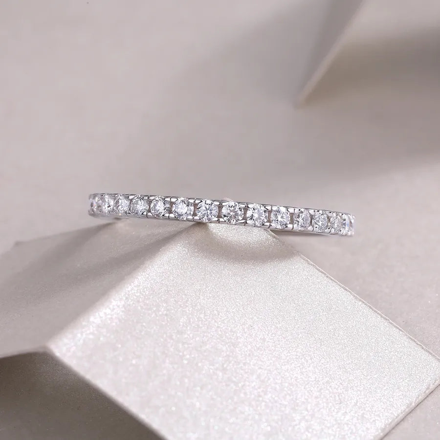 Diamond eternity ring on a soft fabric background