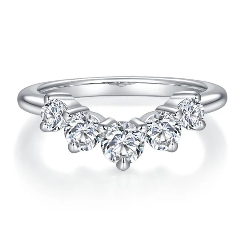 Silver ring with heart-shaped diamonds on a white background