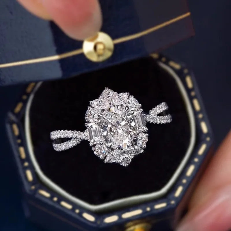 Diamond ring in a blue jewelry box held by a hand