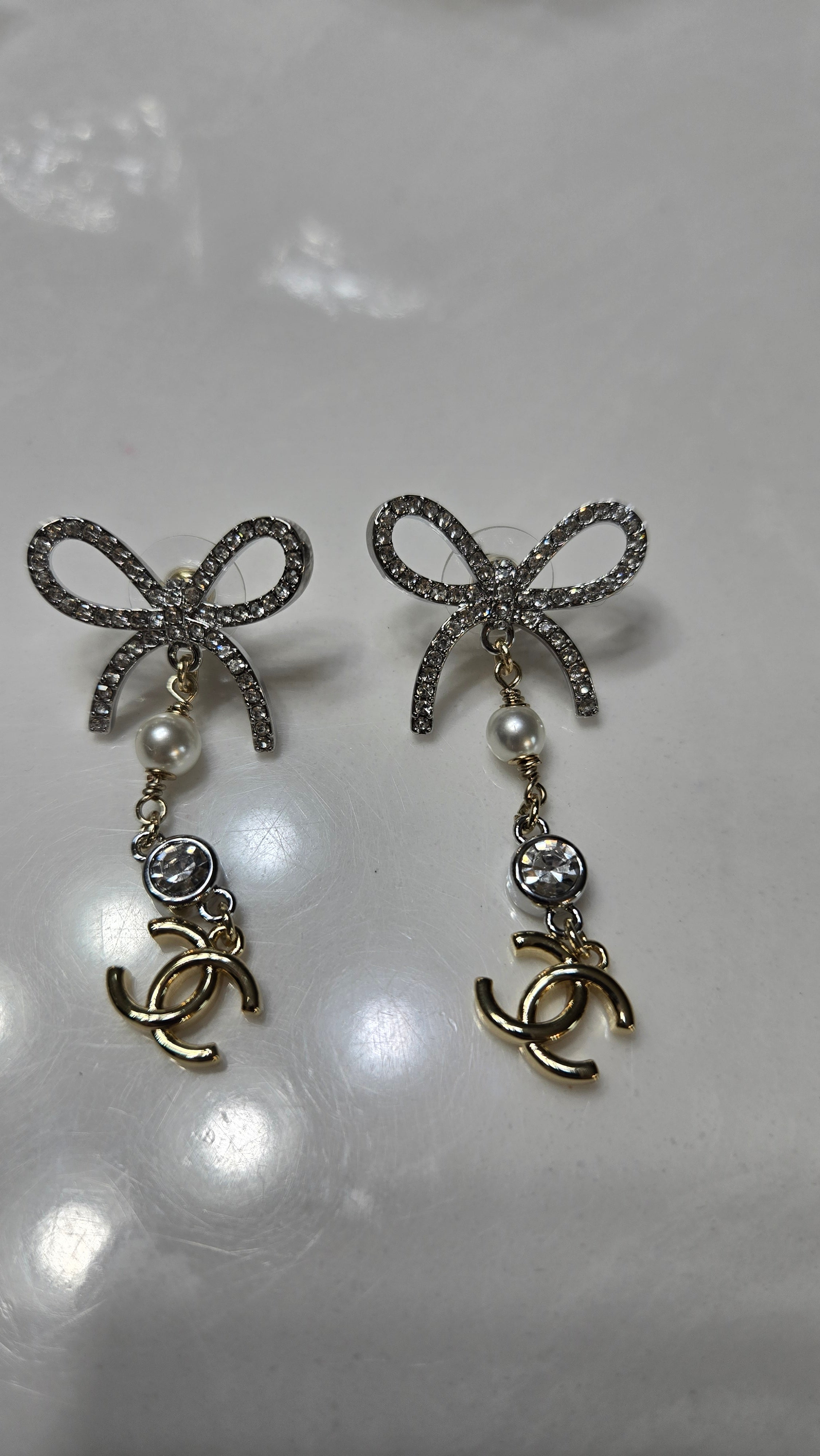Crystal Bow Drop Earrings with Pearl & Interlocking C-Style Charm – Gold & Silver Tone